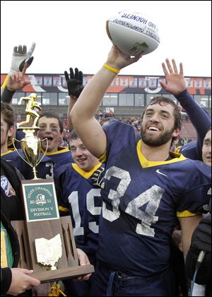 Kirtland running back Christian Hauber (34) celebrates winning the Ohio High School  Division V State Football Championship at Paul Brown Tiger Stadium by beating Coldwater 28-7 in Massillon, Ohio on Friday, Dec. 2, 2011. Hauber had 196 yards and two touchdowns in the victory.  