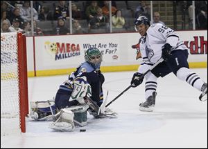 Toledo Walleye goalie Ryan Zapolski, 35, stops a shot by Chicago Express player Caz Johnson, 98, during an Express power play during the second period at the Huntington Center, Saturday.