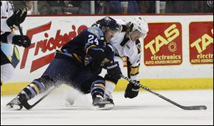 Toledo Walleye player Christopher DiDomenico, 24, gets control of the puck as he battles Cincinnati  Cyclones player Brent Clarke, 25, during the second period at Huntington Center, Friday.
