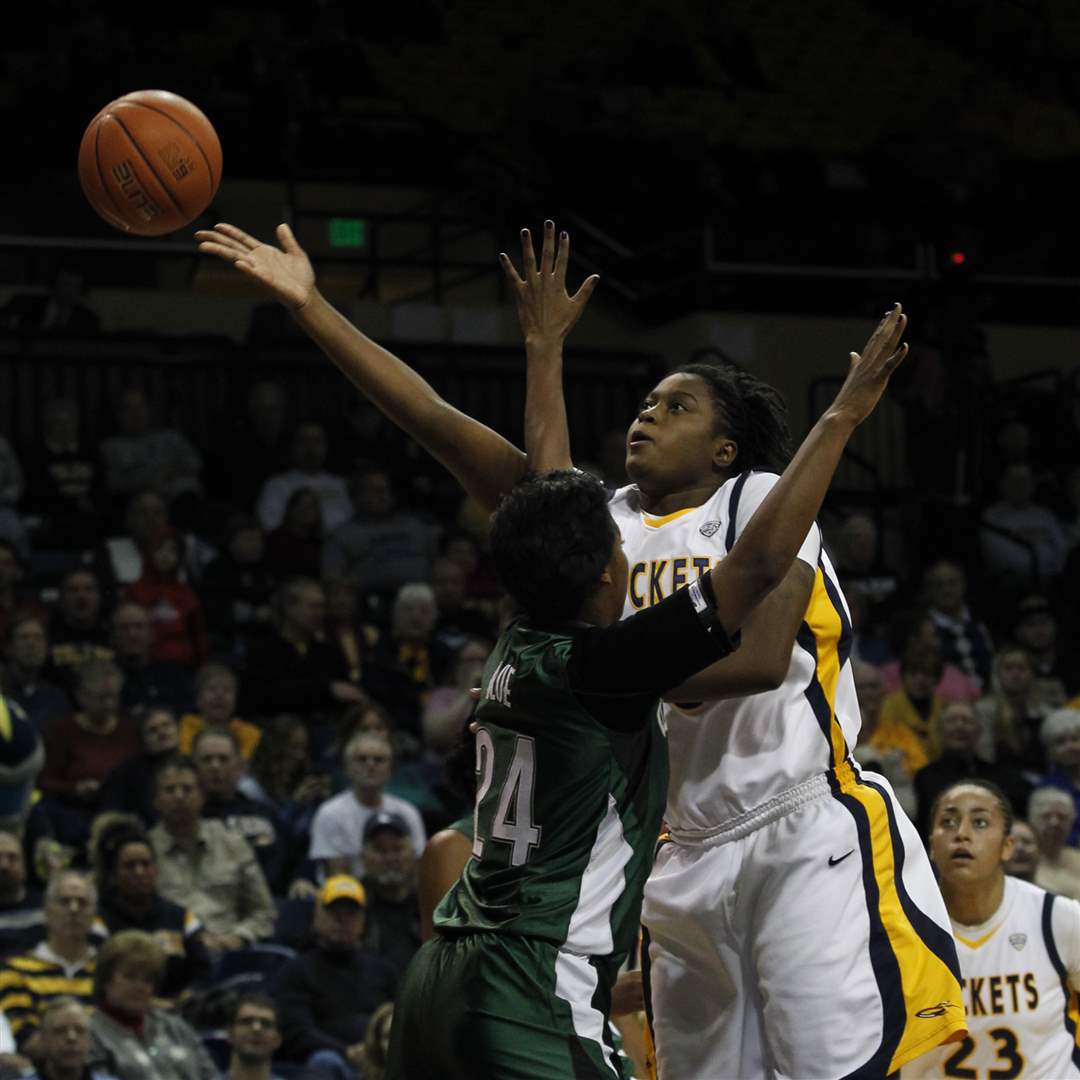 UT-s-Jones-flips-a-ball-to-the-hoop-with-Cleveland-State-s-Blue-in-her-face