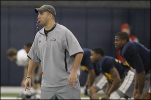 Matt Campbell, University of Toledo's new interim football coach, runs drills with his players during practice at the UT campus on Friday.
