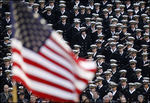 Navy Midshipmen salute during the national anthem before the 112th game played against Army. 