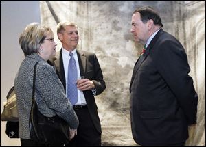 Sandy Tober and her husband, Rick Tober, speak with Mike Huckabee at the annual benefit banquet at the SeaGate Convention Centre. Among the guests in attendance was Toledo Mayor Mike Bell.
