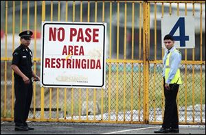 Two airport security guards stand outside Tocumen international airport in Panama City, before the arrival of former dictator Manuel Noriega during his extradition from France.