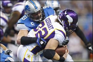 Vikings running back Toby Gerhart (32) is tackled by Lions defensive end Kyle Vanden Bosch (93) in the first quarter.