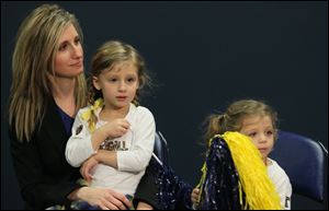 Matt Campbell's wife Erica Campbell and daughters Katie, 3, and Izzy, 2, listen as he is named head football coach of the University of Toledo Rockets.