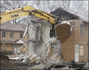 Work crews begin demolition of the Albertus Brown housing project in Toledo.