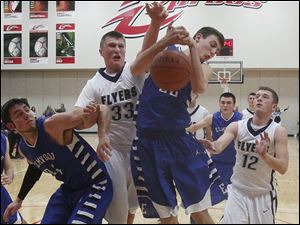 Elmwood's Mat Zyski (34) and Austin Hoiles (23) struggle for a rebound with Lake's Jayce Vancena (33) and Nathan Pennington (12) during a game at Owens.