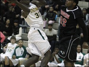 Start's Scott Hicks leaps for a basket while being guarded by Rogers' DeVonte Pratt. Hicks had 10 points in the loss.