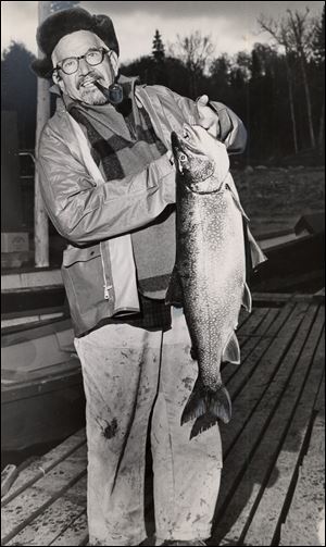 Lou Klewer, displaying a Coho salmon in 1966, began writing for The Blade about the outdoors in 1924 and during his nearly 60-year career at the newspaper earned more than 25 major awards.