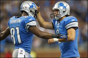 Detroit Lions' Matthew Stafford (9) congratulates teammate Calvin Johnson (81) on his touchdown. Detroit will have more to celebrate if it beats San Diego on Saturday, and clinches its first playoff berth since 2000.
