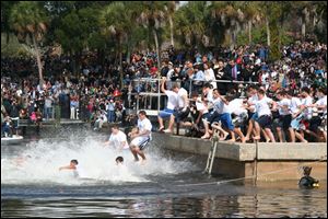 Boys jump into the water in Tarpon Springs, Fla., in preparation for the annual race to a cross tossed in the water on the Christian holiday of Epiphany.