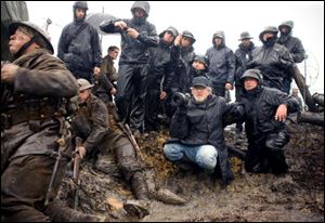 Director Steven Spielberg, center, films a scene in 