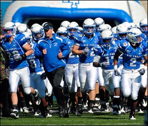Air Force coach Troy Calhoun leads his team onto the field at Falcon Stadium. Calhoun has guided the Falcons to a 41-23 record in five seasons (2-2 in bowls).