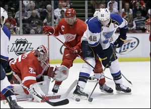 St. Louis Blues center David Backes (42) tries shooting the puck past Detroit Red Wings defenseman Nicklas Lidstrom (5) and goalie Jimmy Howard (35) during the first period of an NHL hockey game in Detroit, Tuesday.