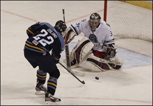 Walleye's Nick Oslund attempts to score against Chicago goalie Paul Dainton during game at the Huntington Center in Toledo, Ohio.