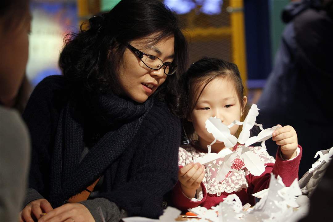 Yunju-Seo-left-Bowling-Green-admires-the-snowflake-made-by-her-daughter