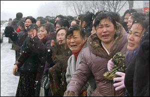 Mourners cry during the funeral procession for late North Korean leader Kim Jong Il.