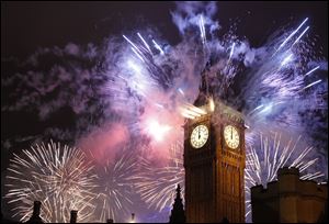 Fireworks explode over the Houses of Parliament, including St Stephen's Tower which holds the bell known as Big Ben as London celebrates the arrival of New Years Day Sunday.