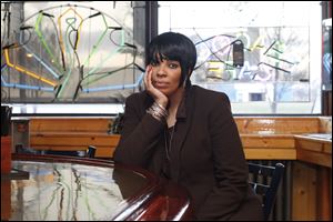 Karen Harris, sitting at the Peacock Cafe, says she has forgiven the man convicted of killing her father, Charles Harris, Jr., 71, in a robbery in Toledo last year. Mr. Harris was the city’s oldest homicide victim in 2011.