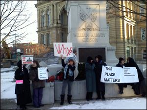 A group of women protest the Seneca County courthouse's demolition Tuesday.