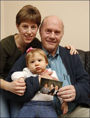 Julia Gonyer, born in 1978, her father, Richard Stiff, born in 1947, and her daughter, Kourtney Gonyer, born in 2011, share Jan. 4 birthdays. Mr. Stiff holds a photo of his father, Marshall, born in 1924, Mrs. Gonyer, and himself celebrating at a local restaurant in 1995.  Marshall Stiff, who lived in West Toledo, died in 2000.