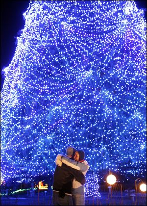 This winter 175,053 attended the Toledo Zoo's "Lights Before Christmas," including Jamie Hamilton, right, Pettisville, who is hugging Mike Altman, Hicksville, after accepting his marriage proposal.