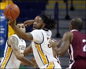 University of Toledo forward Reese Holliday (32) steals the ball from Indiana University-Northwest forward Baile Barnett (2) Tuesday, at Savage Arena in Toledo, Ohio.