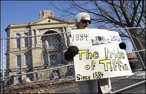 Elva Einsel protests outside of the Seneca County Courthouse. Ms. Einsel, who is 83, has lived in Tiffin for 21 years and was part of a group of supporters who voiced their anger at the county's decision to demolish the building.