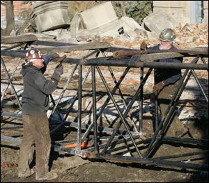 Workers assemble a crane in preparation for the demolition of the courthouse.