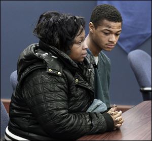 Davion Wilson sits next to his mother, Martina Wilson, during his hearing in Lucas County Juvenile Court. Young Wilson is charged in the shooting death of 17-year-old Deadrick Rocker on Friday.