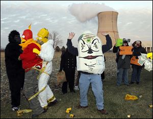 Michael Keegan of Monroe, a member of Don't Waste Michigan, portrays a cracked Humpty Dumpty as he and protesters perform.