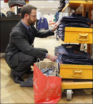 Brad Cheskes of Chicago shops at Macy's on the city's State Street. Shoppers seemed inclined to buy only if they saw huge discounts.