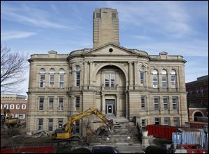 Crews begin to tear down steps of the Seneca County Courthouse facing Market Street in Tiffin, Ohio.