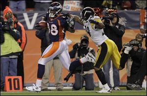 Denver's Demaryius Thomas breaks away from Pittsburgh defensive back Ryan Mundy for the winning touchdown in overtime. The 80-yard score came on the first offensive play of overtime. 