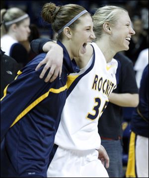 University of Toledo's Taylor Carver, left, and Haylie Linn, right, run onto the court to celebrate their win against Central Michigan.