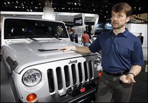 Jeep CEO and President Mike Manley speaks while standing next to a Jeep Wrangler Unlimited Call of Duty Edition.