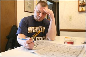 Matthew Stookey, left, laid off from a construction job, filed recently for unemployment and fears he won’t find a new job.
