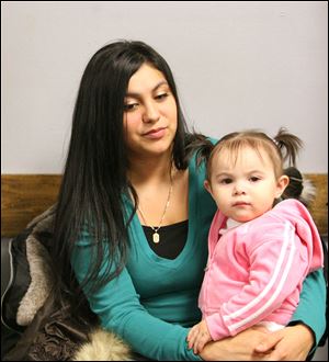 Angela Rios, a nursing student and single mother of 1-year-old Alina, is representative of a new group, those in ‘situational poverty’ because of circumstances such as job loss.