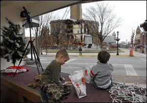 Brothers Lance, left, and Carter Clouse watch the demolition from the Assured Title Agency.
