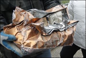 The partially crushed box was taken to a county maintenance garage and pried open there. The box was made by a Tiffin man and the items inside were in good shape. 