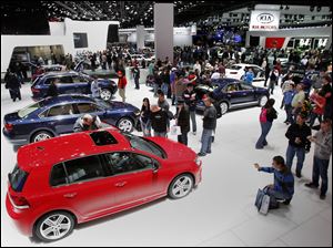 Car fans check out vehicles at the North American International Auto Show in Detroit, Mich.