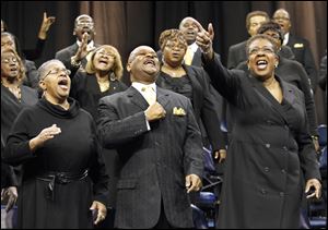 Members of the Toledo Interfaith Mass Choir, including from front left, Elaine Hunter, Marvin March, and Cerssandra McPherson, perform during the 11th annual Dr. Martin Luther King Jr. Unity Celebration in Savage Arena at the University of Toledo.