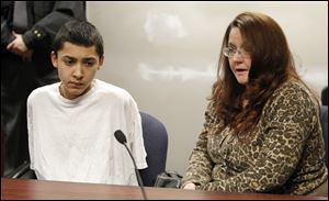 Jacob Rodriguez, left, listens as his mother, Danalle Williams, tell the judge her son is innocent and does not need to remain in custody. The judge ordered the youth be held in detention because of the crime's seriousness.