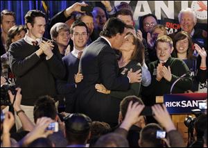 Republican presidential candidate Rick Santorum embraces his wife, Karen, surrounded by their children in Iowa. He has seven children, the same number as Jon Huntsman, who dropped out of the race.