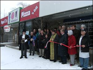 The ribbon cutting ceremony at Papa G's Pizza in the South Briar Shopping Center in Sylvania.