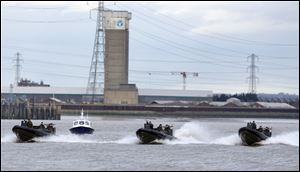 Police and Royal Marines boats perform a combined Police and Royal Marines security exercise Thursday on the River Thames in London.
