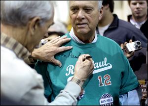 Irvind Borgan of James Island, S.C., gets his T-shirt autographed by Republican presidential candidate Ron Paul during a campaign rally Friday in an airplane hanger in North Charleston, S.C. 