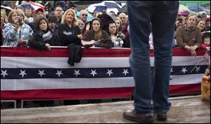 Supporters for Republican presidential candidate Mitt Romney listen to him speak Friday during a campaign stop at Harmon's Tree Farm in Lexington, S.C.