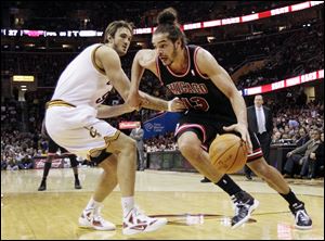 The Bulls' Joakim Noah drives the lane against the Cavs' Semih Erden in the first quarter in Cleveland on Friday.